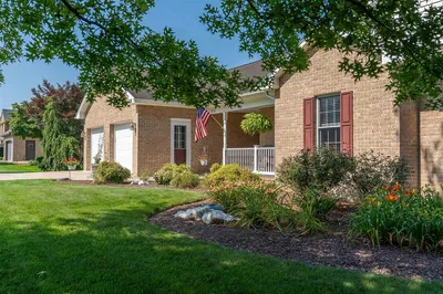 Brick home with American flag and landscaped yard in Belmont Estates, Harrisonburg VA
