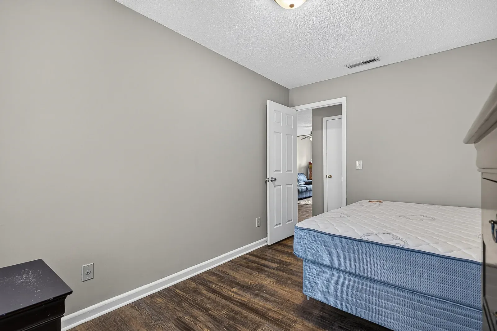 Empty bedroom at 1319 Bradley Dr with wood-look flooring, a ceiling fan, and a window