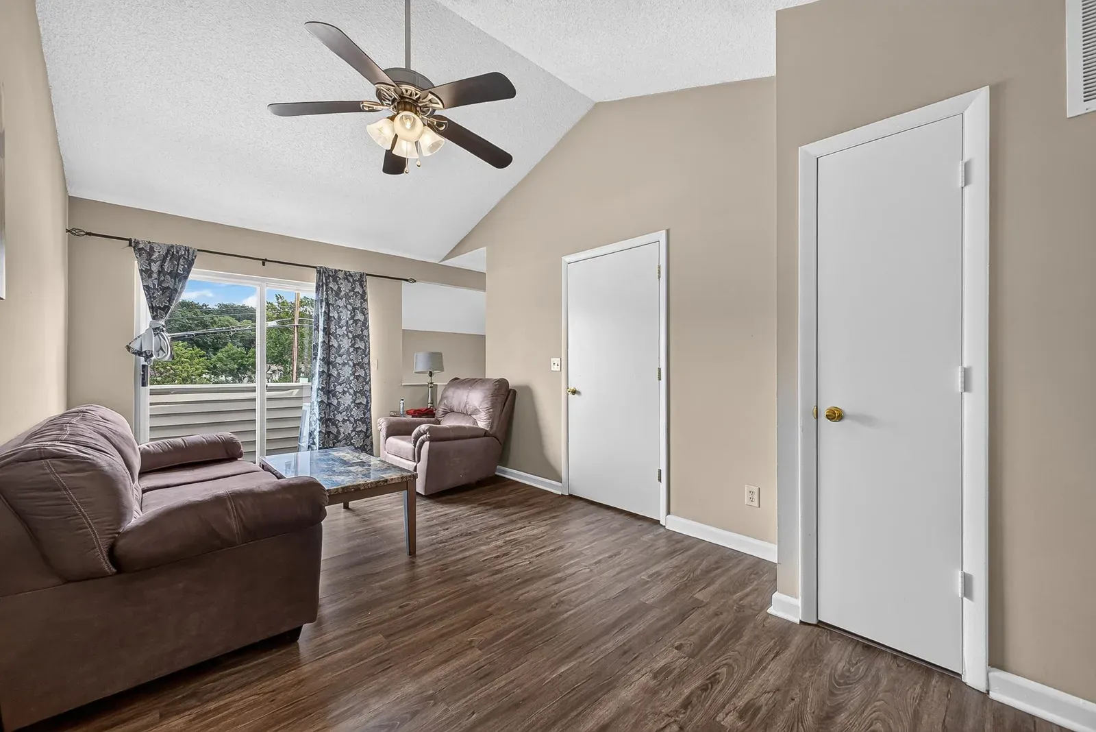 Upstairs family room at 1319 Bradley Dr with a vaulted ceiling, ceiling fan, and windows looking out toward the ridgeline