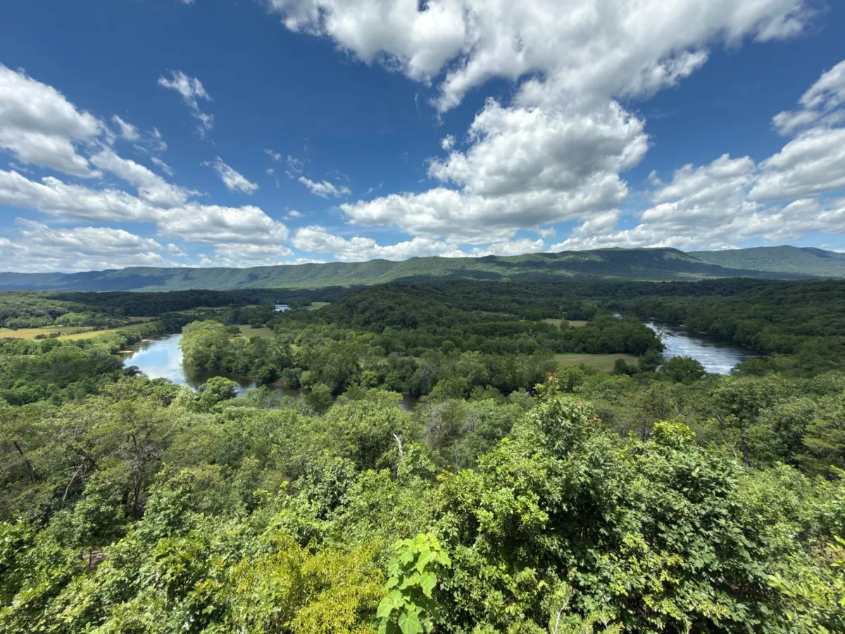 A panoramic view of the Shenandoah Valley with green hills and mountains.