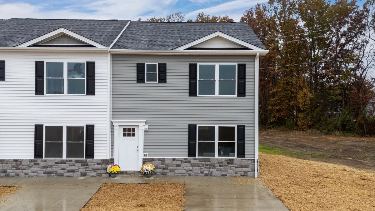 Completed two-story townhome at Forest Station in Grottoes, Virginia, with mums by the front door
