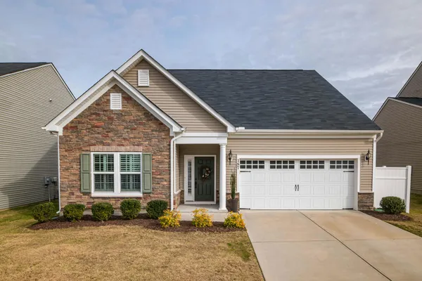 A well-maintained suburban home exterior with a manicured lawn, representing the type of property an appraiser evaluates during a home appraisal