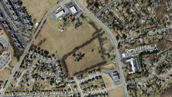 Aerial view of the Weston Park site at 1311 Port Republic Road in Harrisonburg, open fields along the road with subdivisions on either side