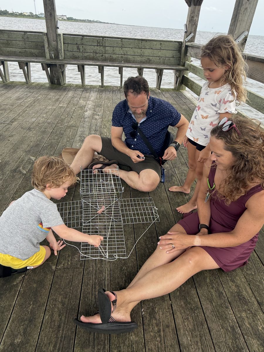 The whole crew rigging the crab trap on the dock